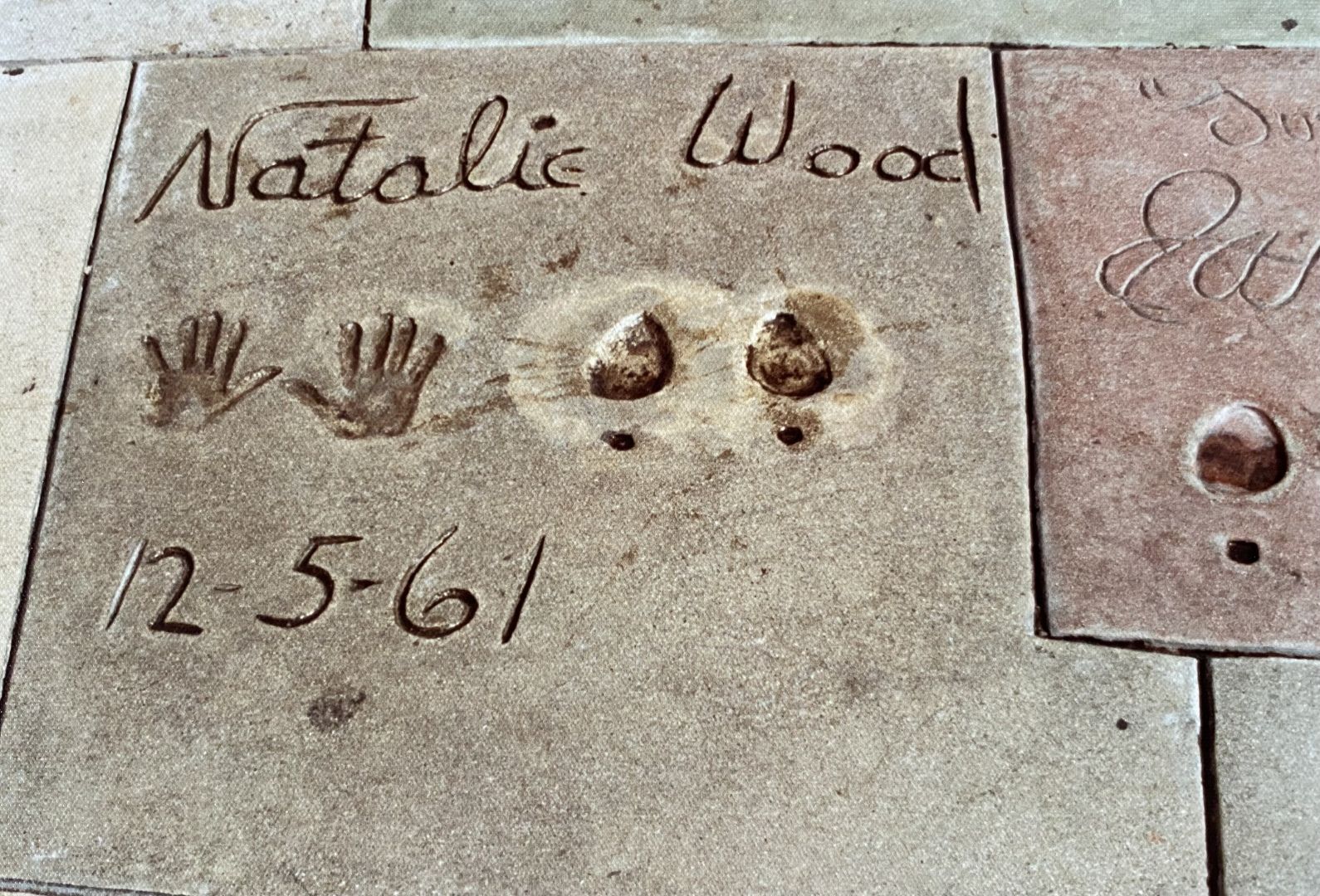 The image shows a concrete slab featuring the etched name 